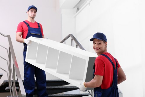 Professional movers handling furniture in Bow