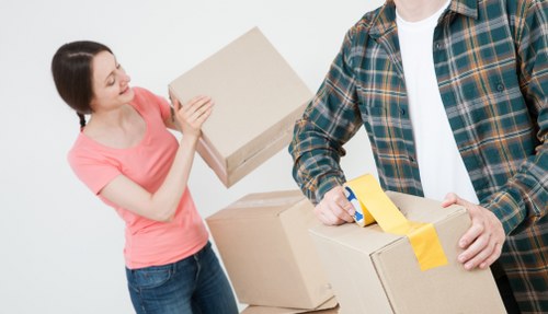 Small removals van handling furniture in Bow