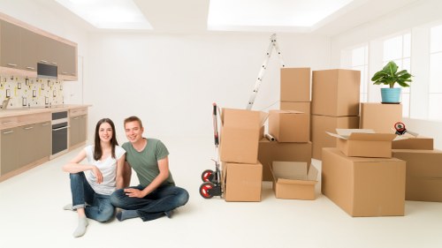 Packed boxes and furniture ready for small removals in Bow